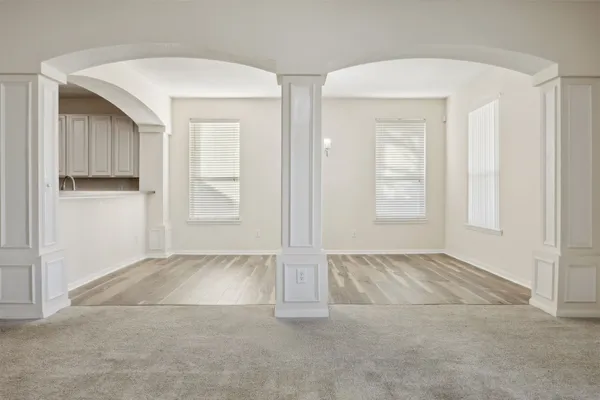 an empty room with windows and closet