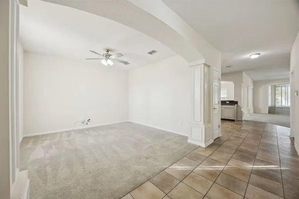 a view of a livingroom with a ceiling fan and window