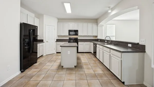 a kitchen with stainless steel appliances granite countertop a sink counter top space and cabinets
