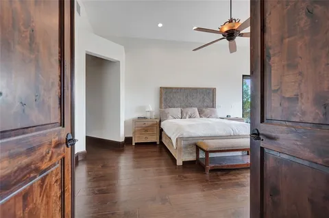 a bedroom with a bed and a chandelier