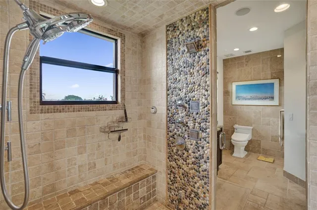 a bathroom with a granite countertop tub a sink and a large mirror