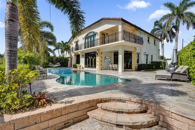 a view of a house with a yard and potted plants
