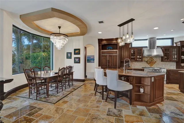 a kitchen with stainless steel appliances granite countertop a sink a stove and a refrigerator