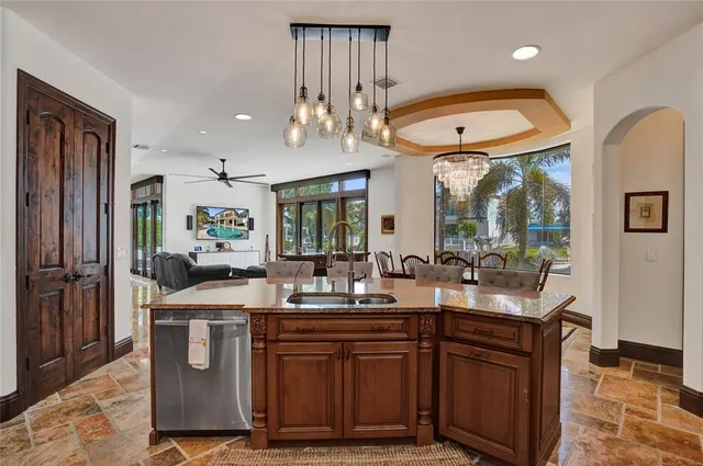 a kitchen with stainless steel appliances granite countertop a sink and stove