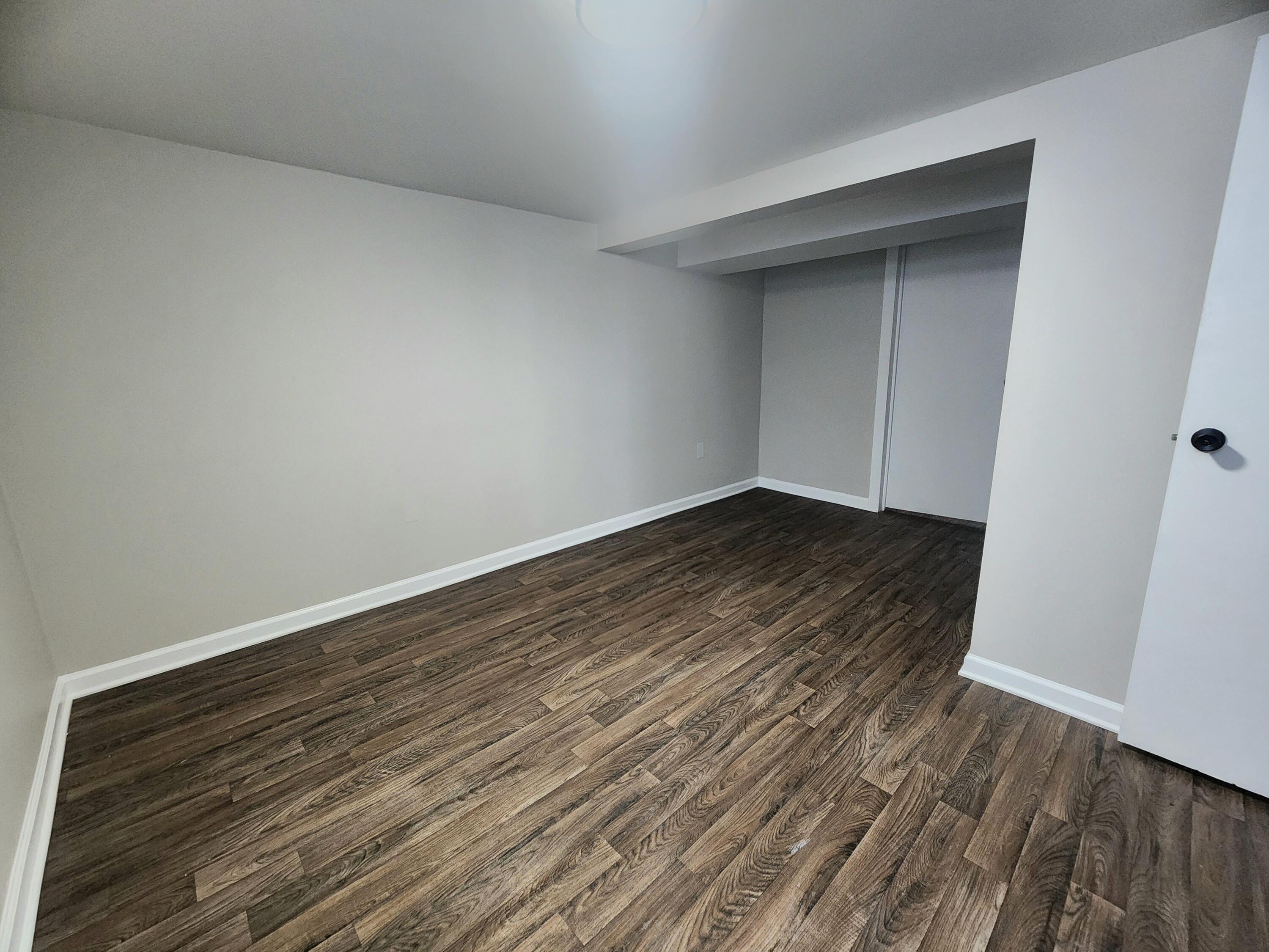 601 Burr Street Gary, IN 46406 - Photo 19 of 24 a view of an empty room with wooden floor and closet