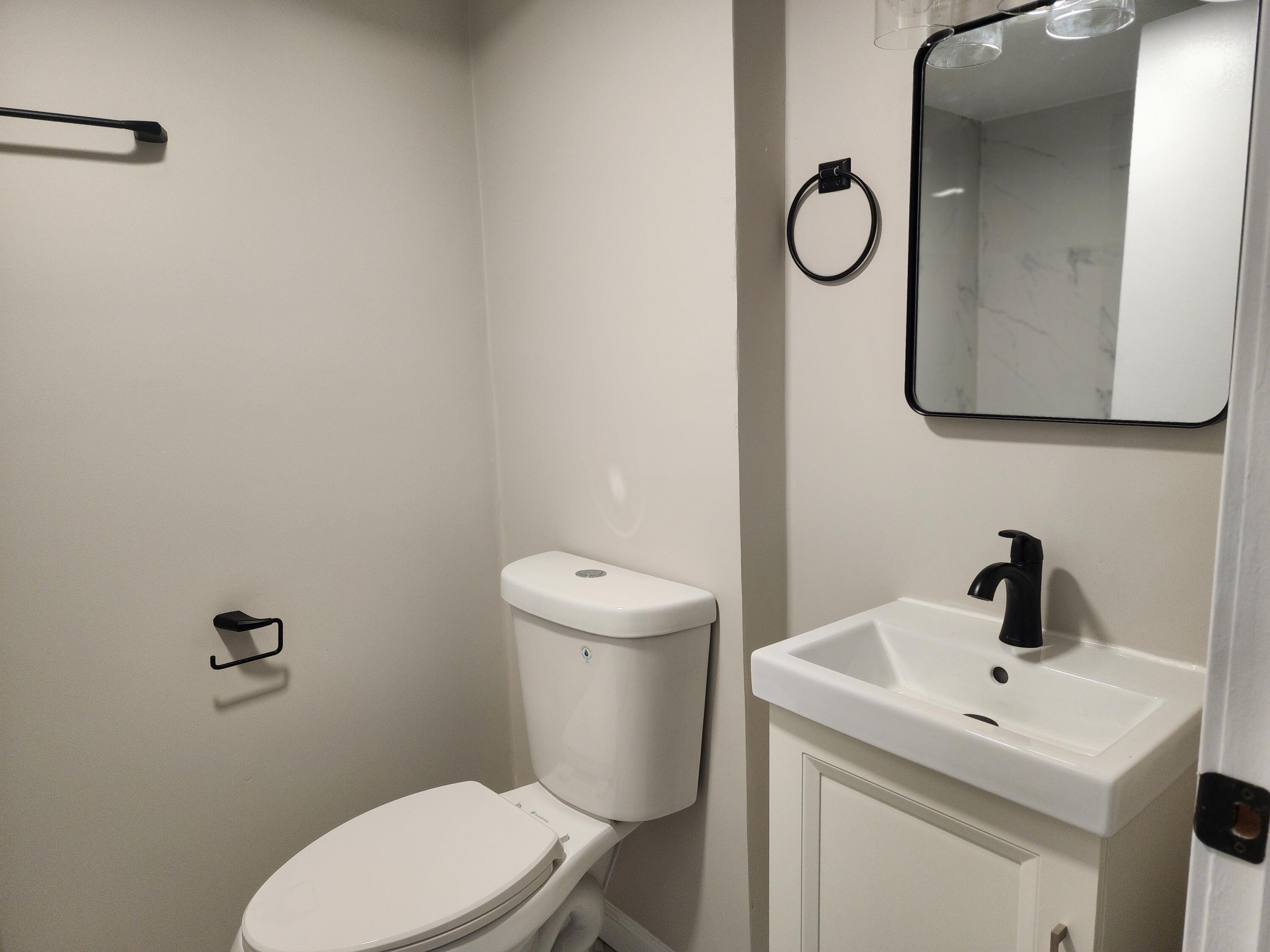 601 Burr Street Gary, IN 46406 - Photo 20 of 24 a bathroom with a toilet sink and mirror