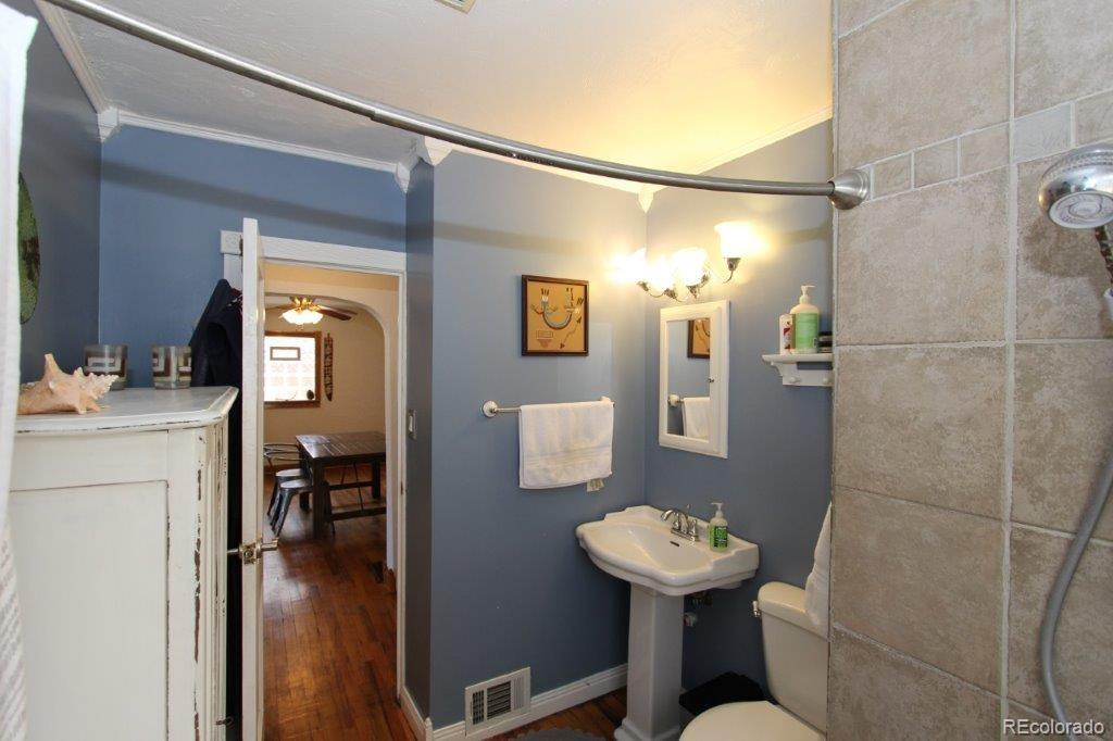 508 East Baseline Road Lafayette, CO 80026 - Photo 15 of 35 a bathroom with a sink a mirror and a shower