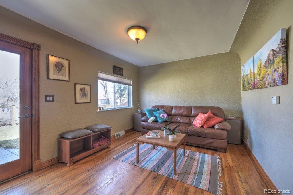 508 East Baseline Road Lafayette, CO 80026 - Photo 3 of 35 a living room with furniture and a wooden floor