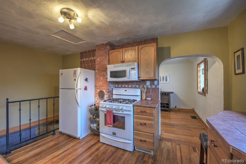 508 East Baseline Road Lafayette, CO 80026 - Photo 8 of 35 a kitchen with stainless steel appliances a stove refrigerator and microwave