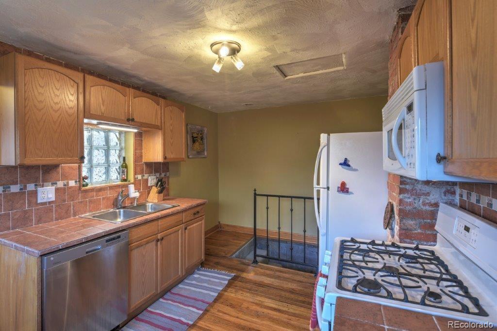 508 East Baseline Road Lafayette, CO 80026 - Photo 10 of 35 a kitchen with sink cabinets and appliances