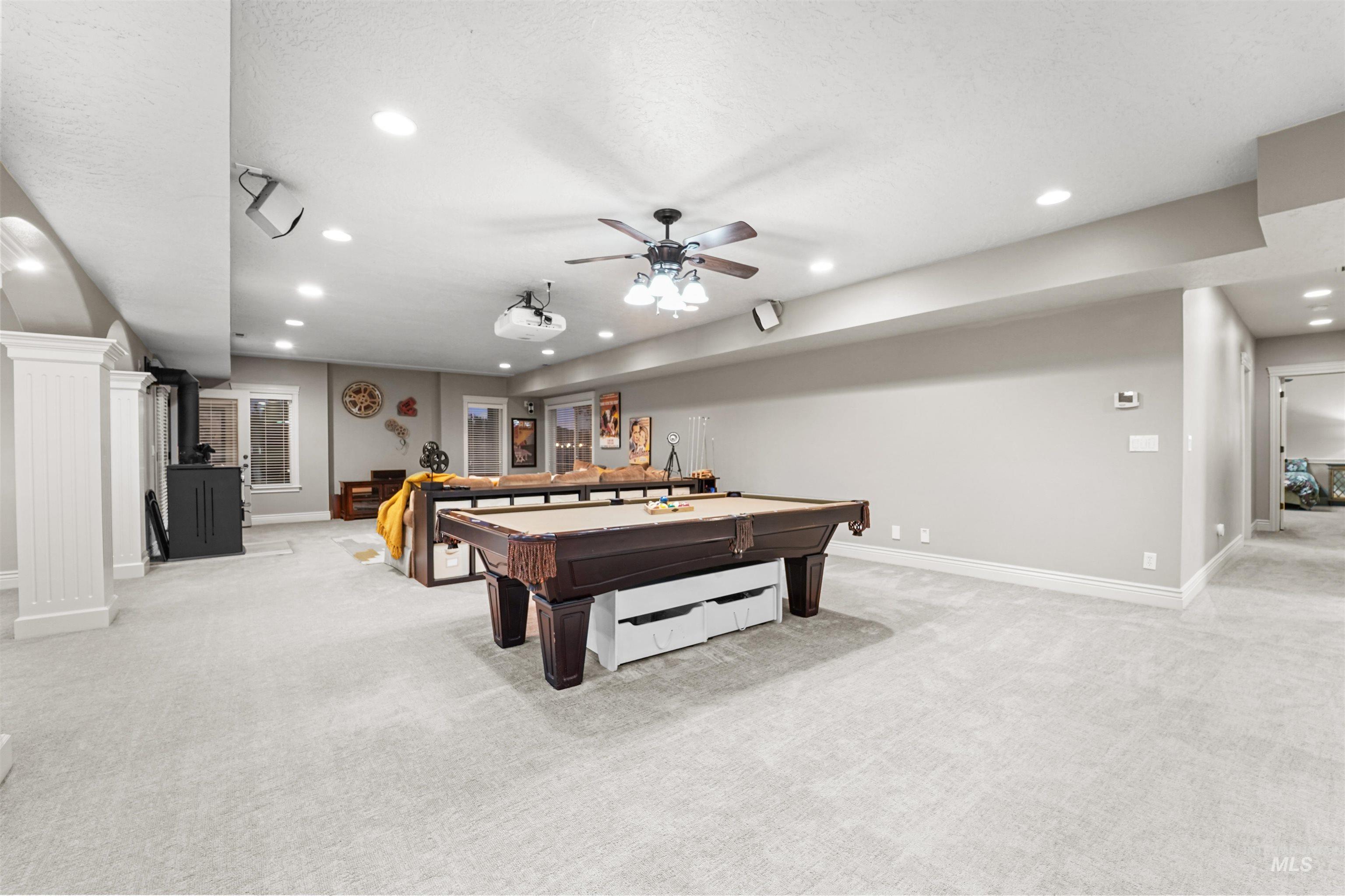 10430 Randall Lane Caldwell, ID 83607 - Photo 18 of 39 Rec room with light colored carpet, recessed lighting, pool table, a ceiling fan, and a wood stove