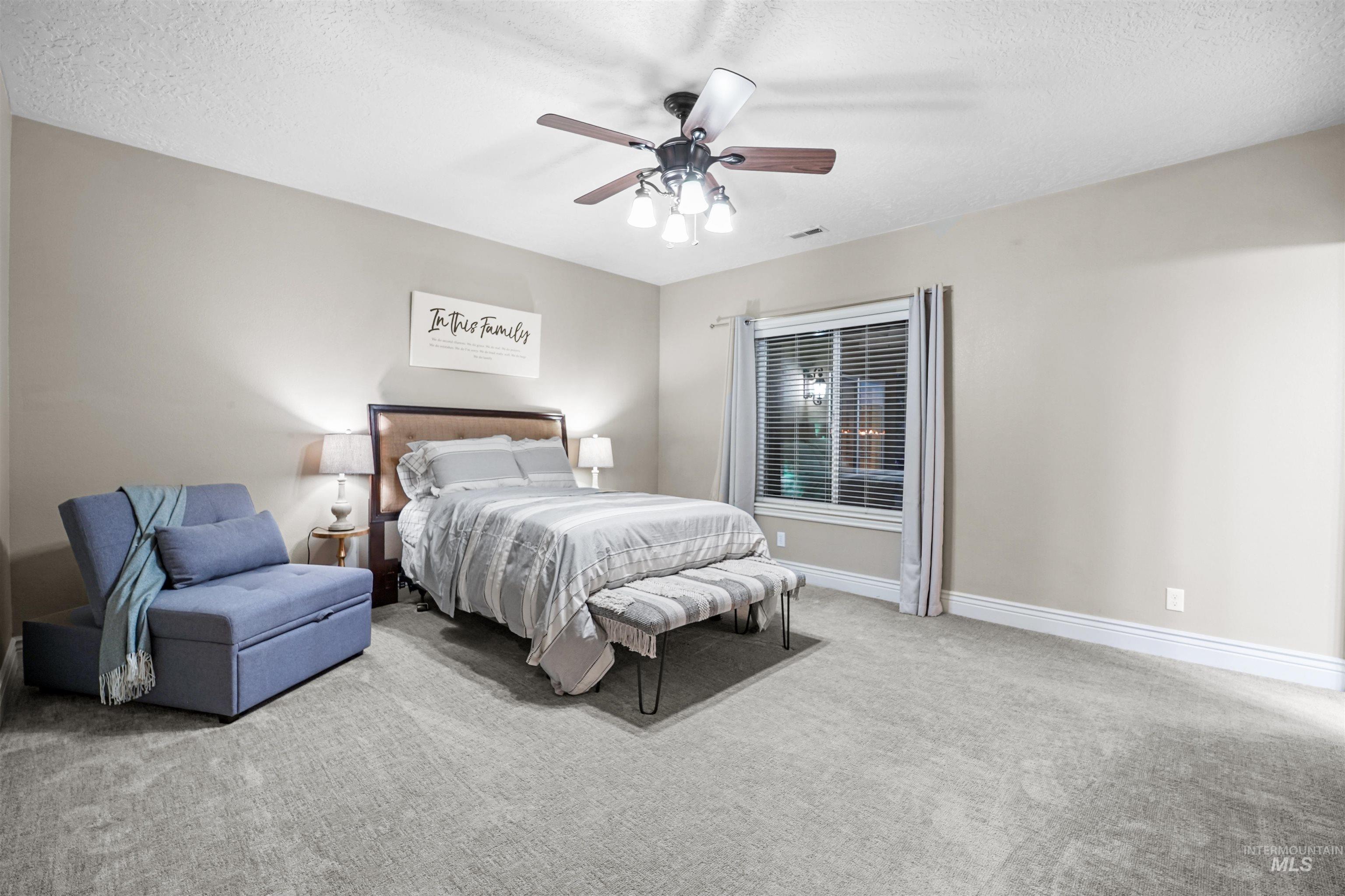 10430 Randall Lane Caldwell, ID 83607 - Photo 21 of 39 Carpeted bedroom with a textured ceiling and ceiling fan