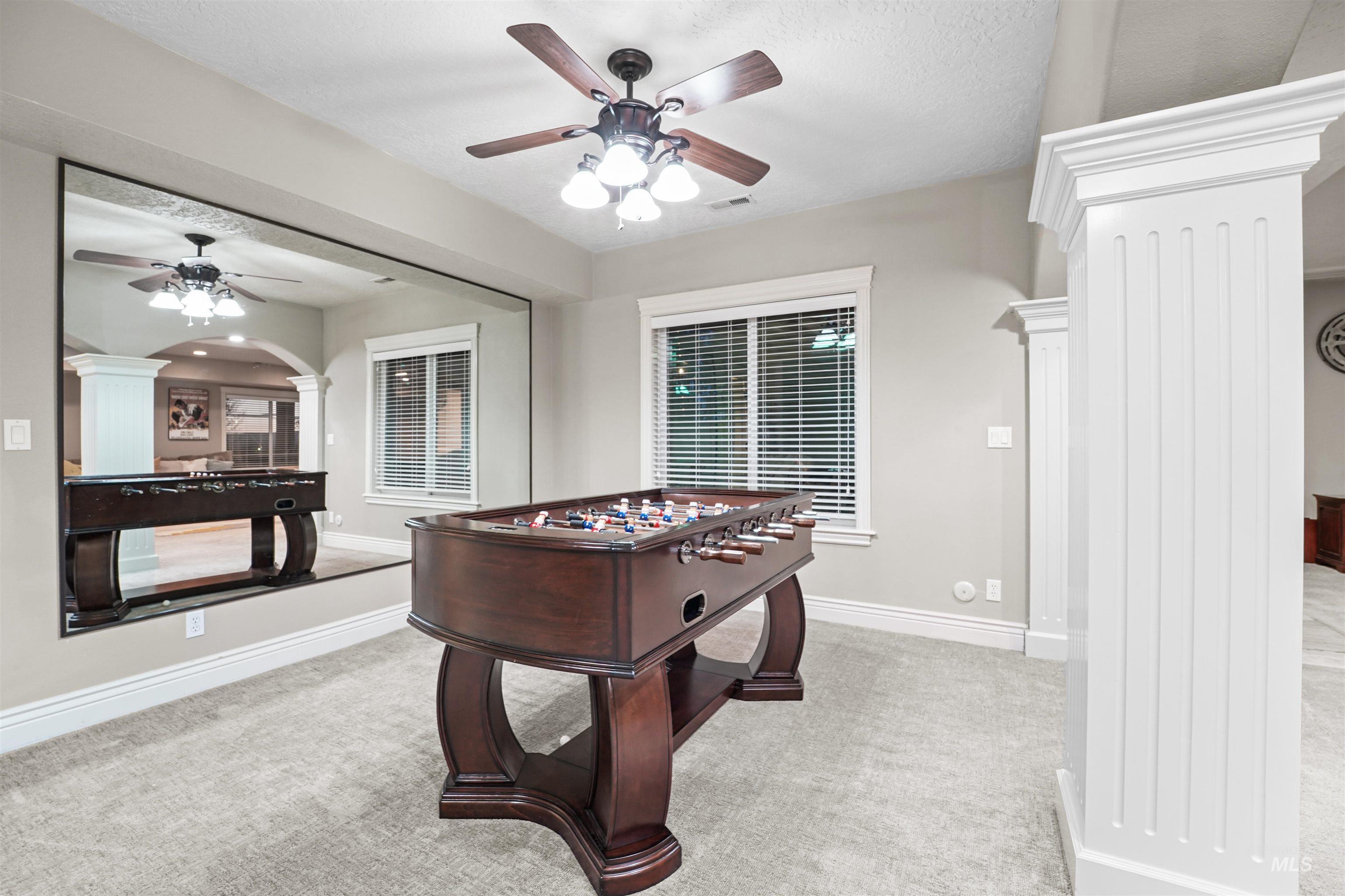 10430 Randall Lane Caldwell, ID 83607 - Photo 22 of 39 Rec room featuring ornate columns, ceiling fan, and carpet