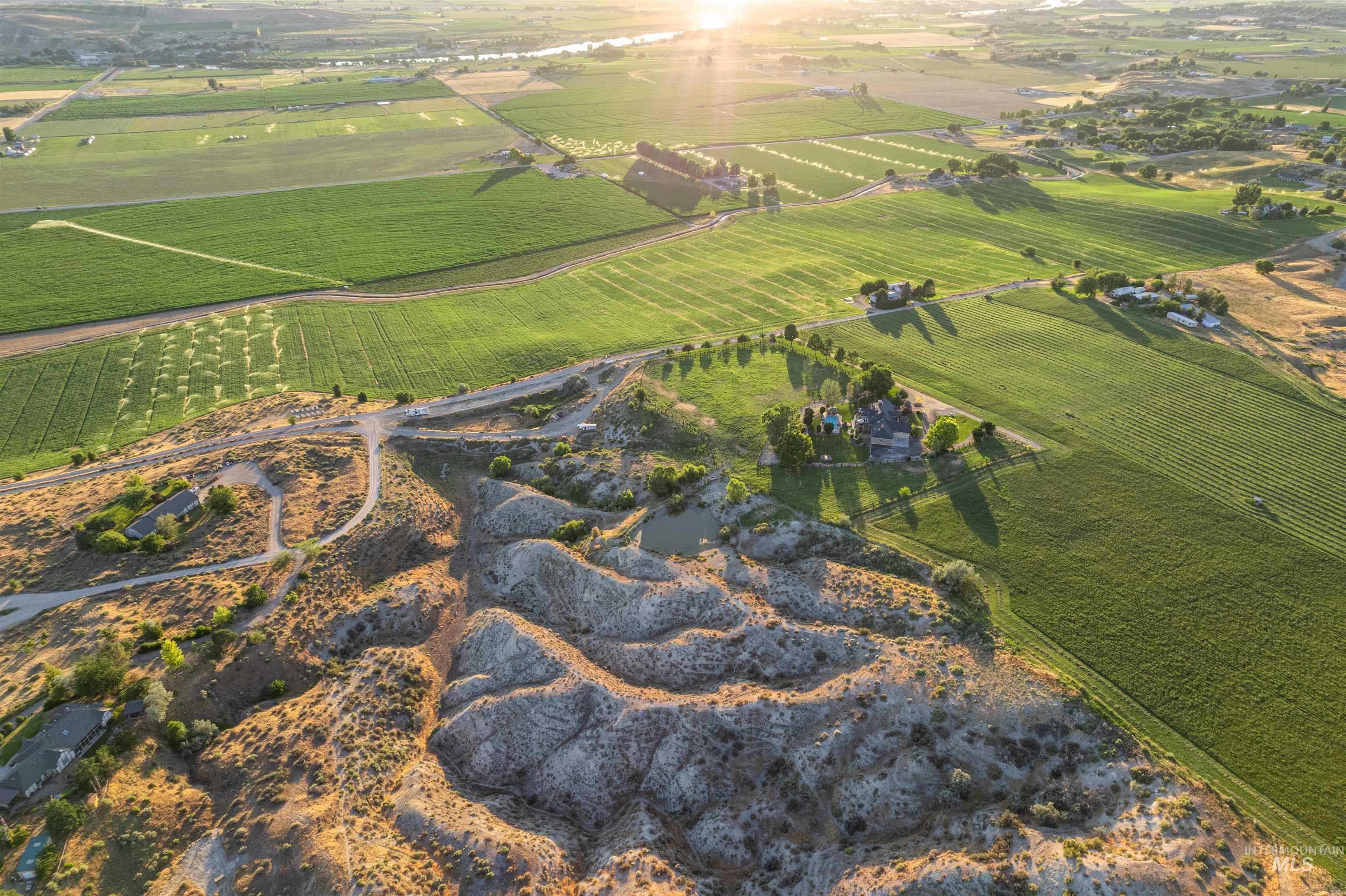 10430 Randall Lane Caldwell, ID 83607 - Photo 27 of 39 Aerial view of property and surrounding area with rural landscape and rows of crops