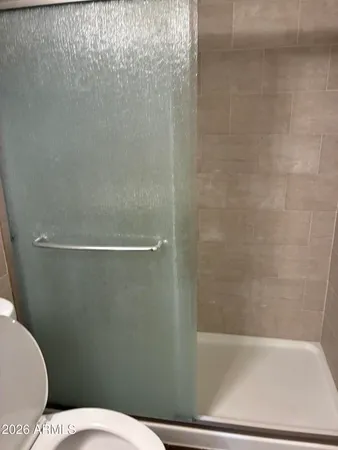 a bathroom with a toilet and a bath tub