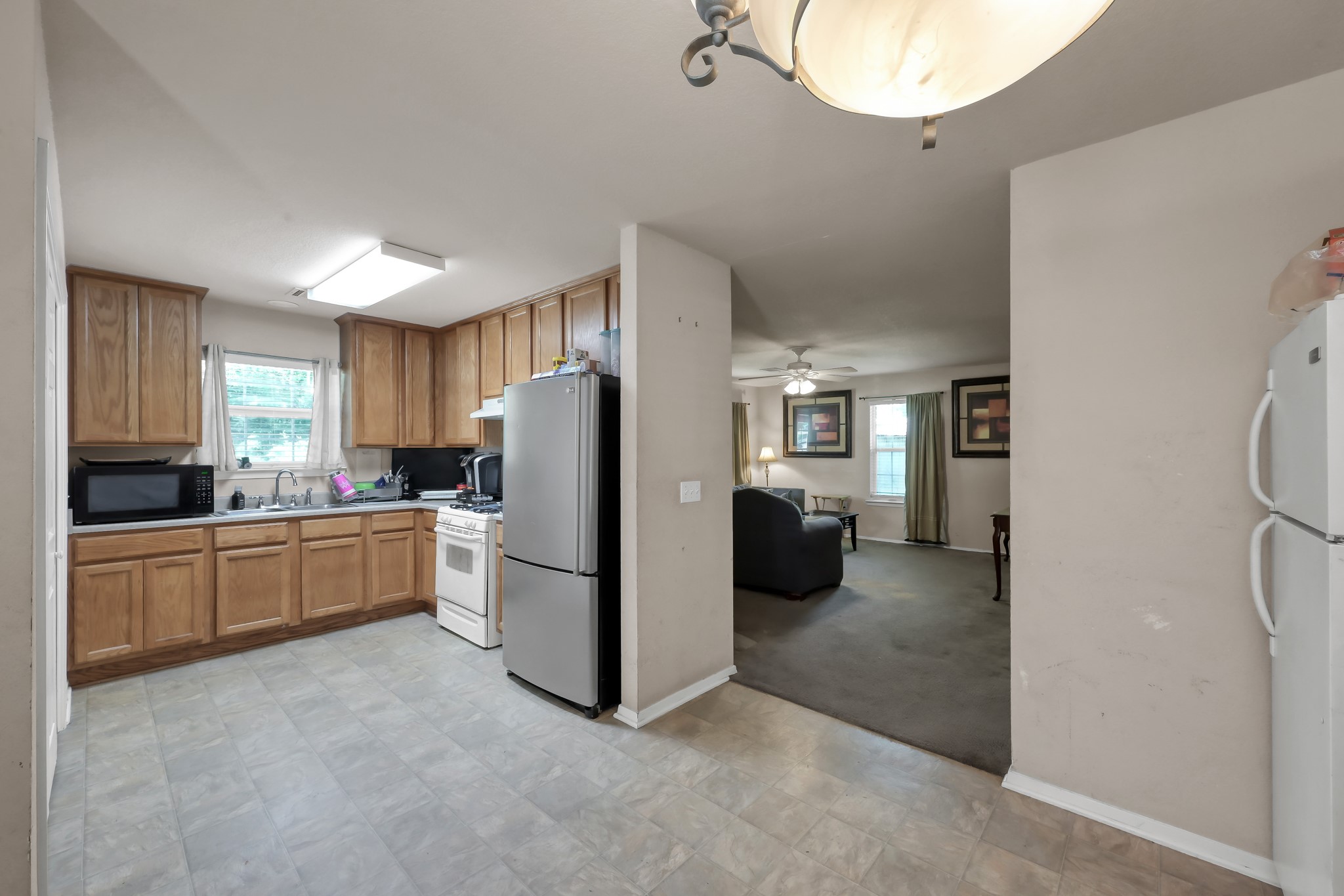 805 Webb Street Conroe, TX 77301 - Photo 10 of 19 a kitchen with a refrigerator and a stove top oven