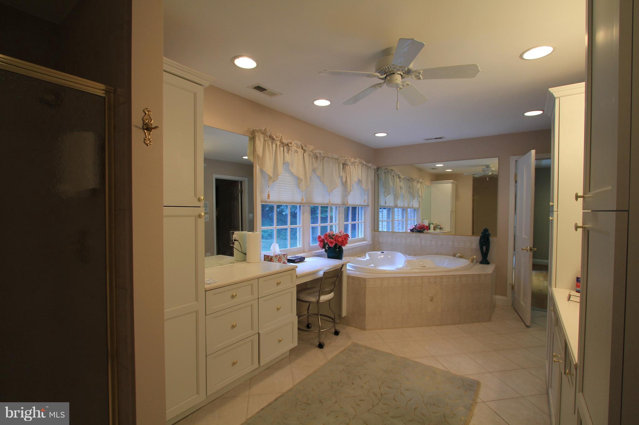 2850 Dunleigh Drive Dunkirk, MD 20754 - Photo 20 of 26 a large bathroom with a sink a large mirror and a bathtub