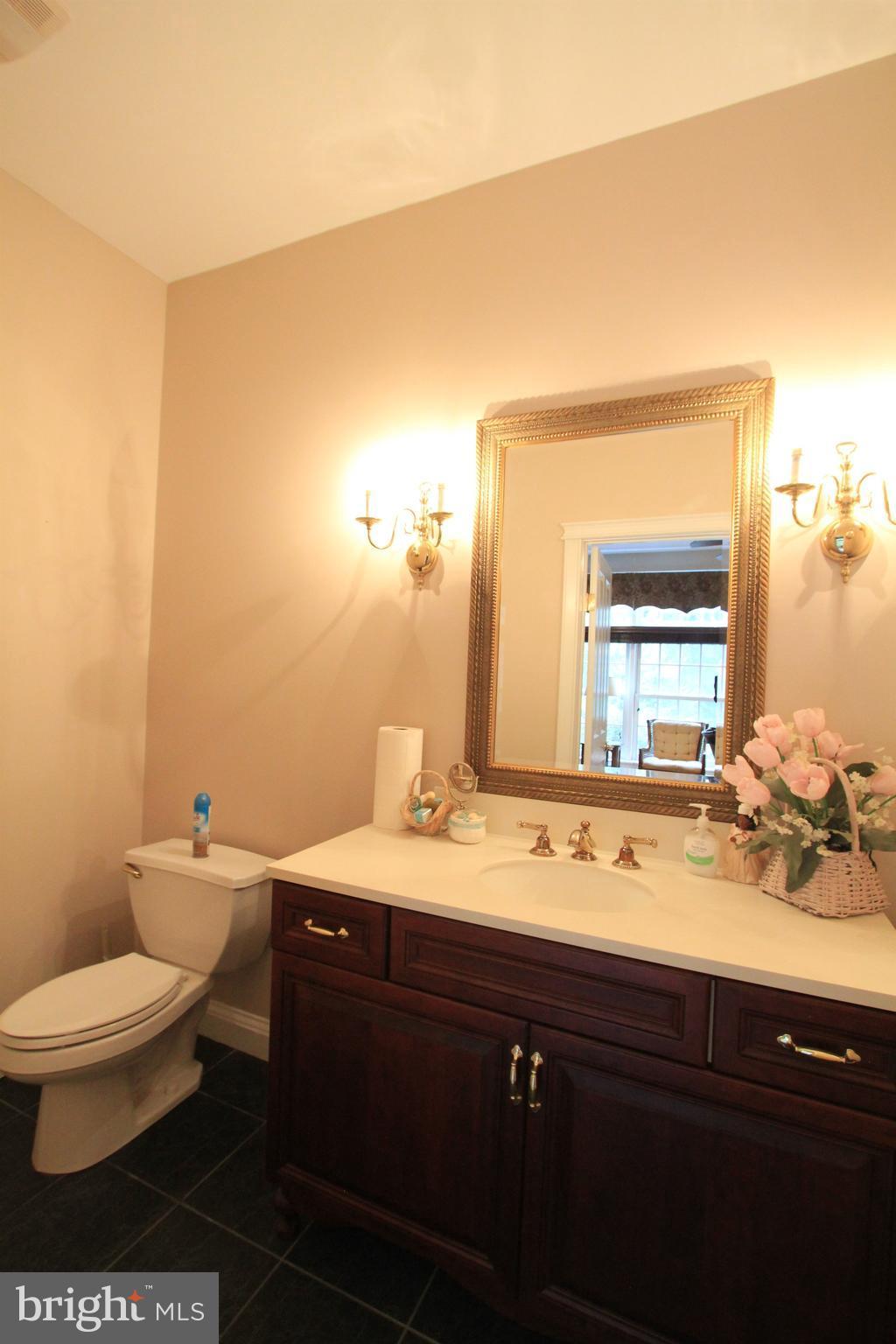 2850 Dunleigh Drive Dunkirk, MD 20754 - Photo 7 of 26 a bathroom with a sink a toilet and mirror