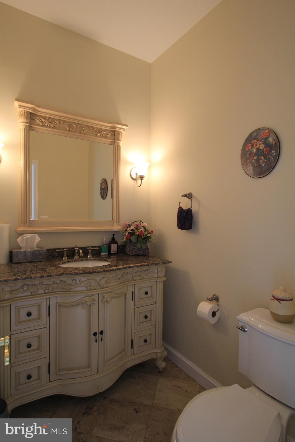 2850 Dunleigh Drive Dunkirk, MD 20754 - Photo 10 of 26 a bathroom with a granite countertop toilet sink and mirror