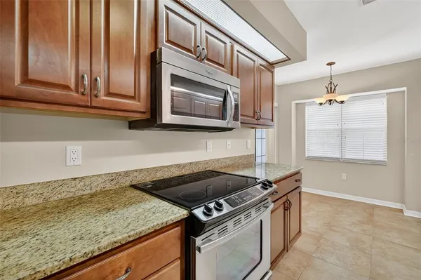 a kitchen with granite countertop a stove and a sink