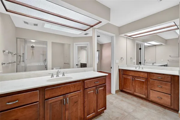 a spacious bathroom with a granite countertop sink mirror and double