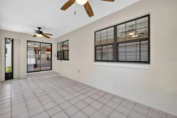 a view of an empty room with window and cabinet