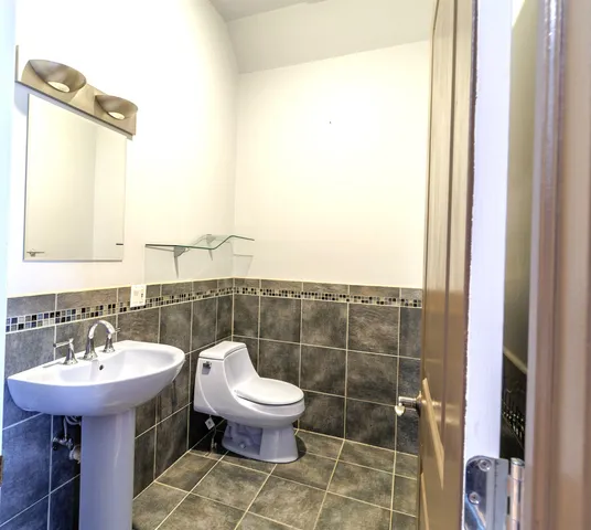 a bathroom with a sink toilet and a mirror