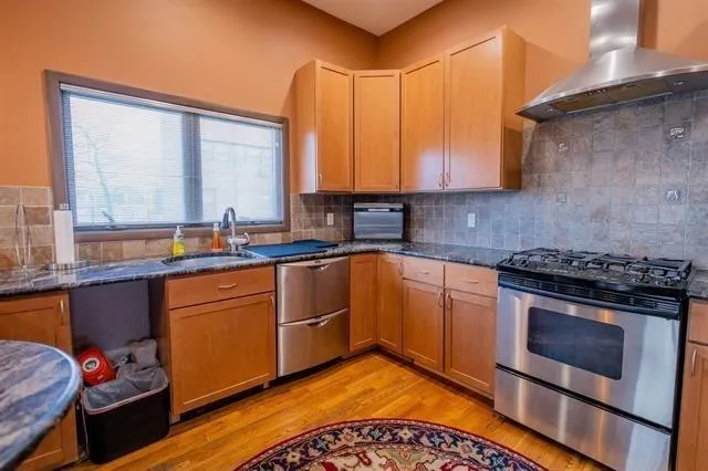 a kitchen with a dining table chairs sink and cabinets