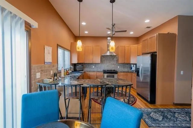 a kitchen with stainless steel appliances granite countertop a stove top oven a sink and cabinets