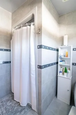 a balcony with table and chairs