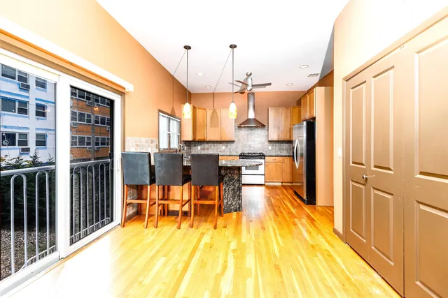 a view of a kitchen with dining room and wooden floor