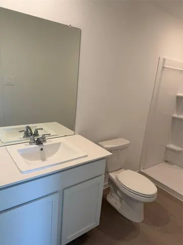 a bathroom with a sink a toilet and mirror