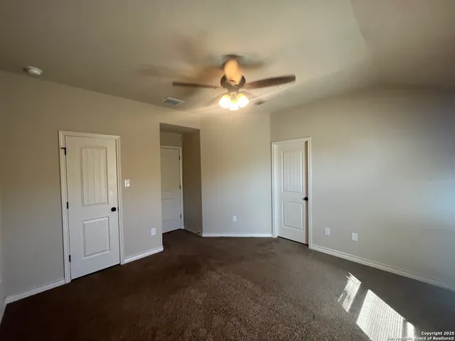 a very nice looking room with a ceiling fan and a window