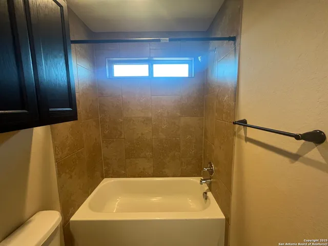 a bathroom with a bathtub and shower