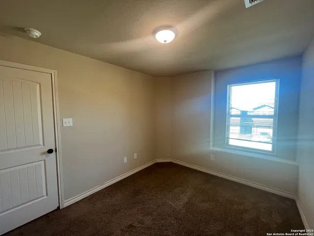 an empty room with a window and windows