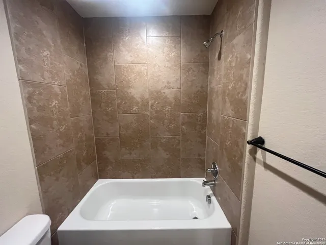 a white toilet sitting next to a bathroom sink