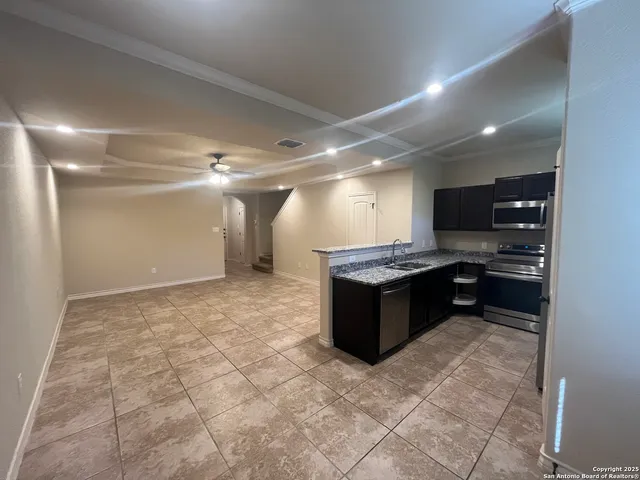 a large kitchen with a stove a sink dishwasher and a refrigerator