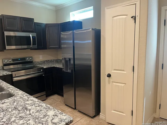 a kitchen with a refrigerator stove and microwave
