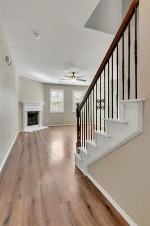 a view of entryway and hall with wooden floor