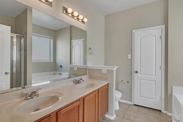 a bathroom with a sink double vanity and a mirror