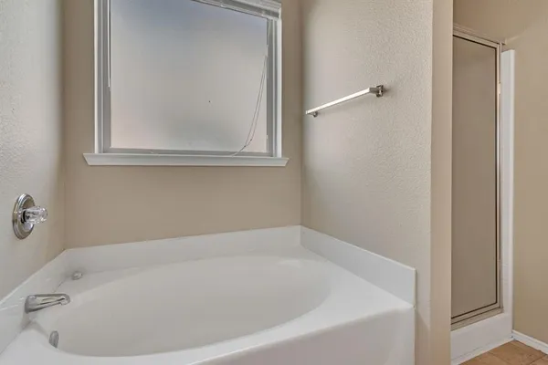 a white bath tub sitting next to a window