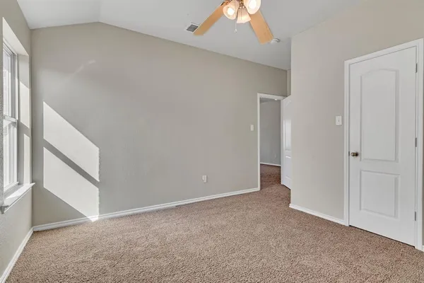 a view of an empty room with windows