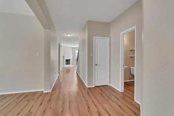 a view of hallway with wooden floor