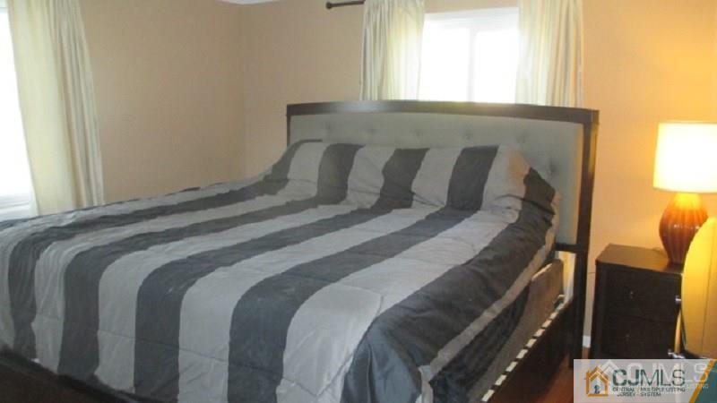 10 Longview Road Old Bridge, NJ 08857 - Photo 6 of 10 a bed sitting in a bedroom next to a window