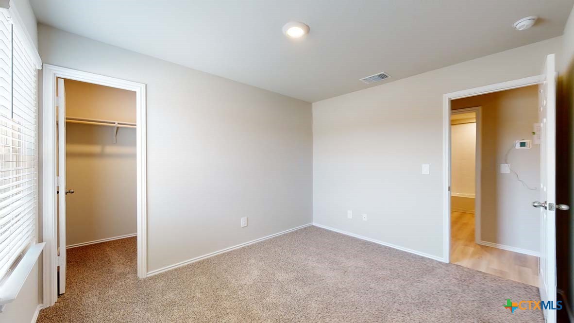 549 Hector Loop Georgetown, TX 78626 - Photo 19 of 22 an empty room with closet and a bathroom