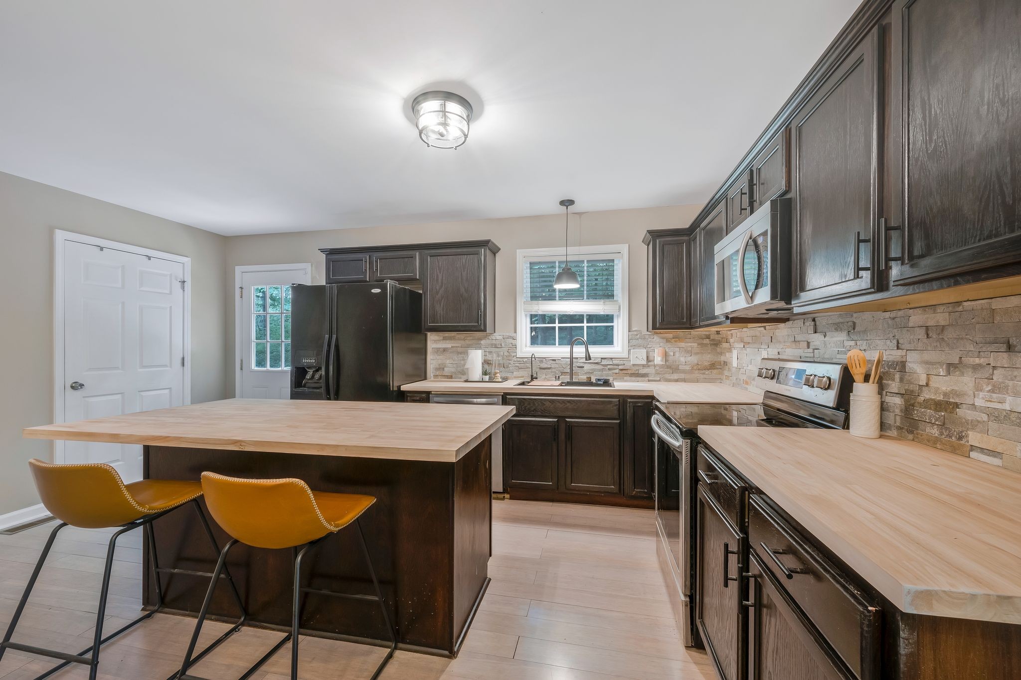238 East Piney Road Dickson, TN 37055 - Photo 3 of 13 a kitchen with stainless steel appliances granite countertop table chairs sink and cabinets