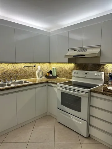 a kitchen with granite countertop cabinets and steel stainless steel appliances