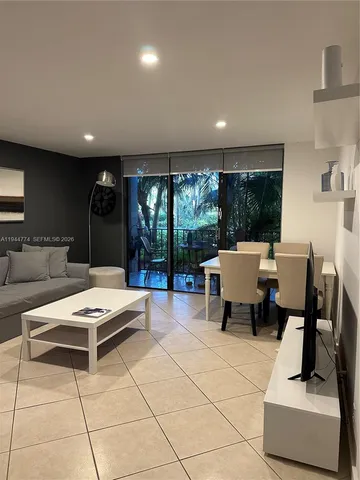 a living room with furniture and white floor