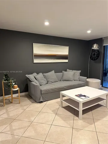 a living room with furniture and white walls