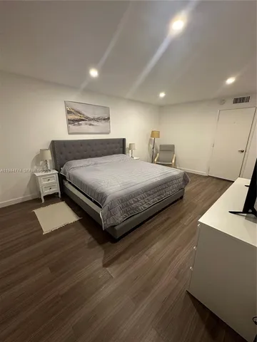 a bedroom with a bed and a table